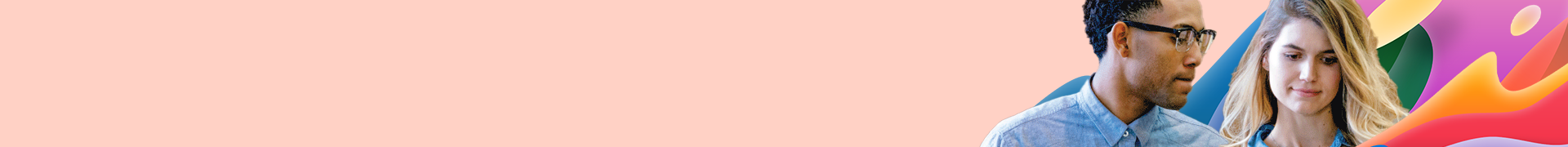 Two students walking and looking at a tablet