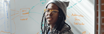 Photo of employee in front of whiteboard