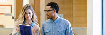 Photo of Microsoft employees looking at tablet