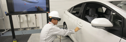 Photo of man working on car