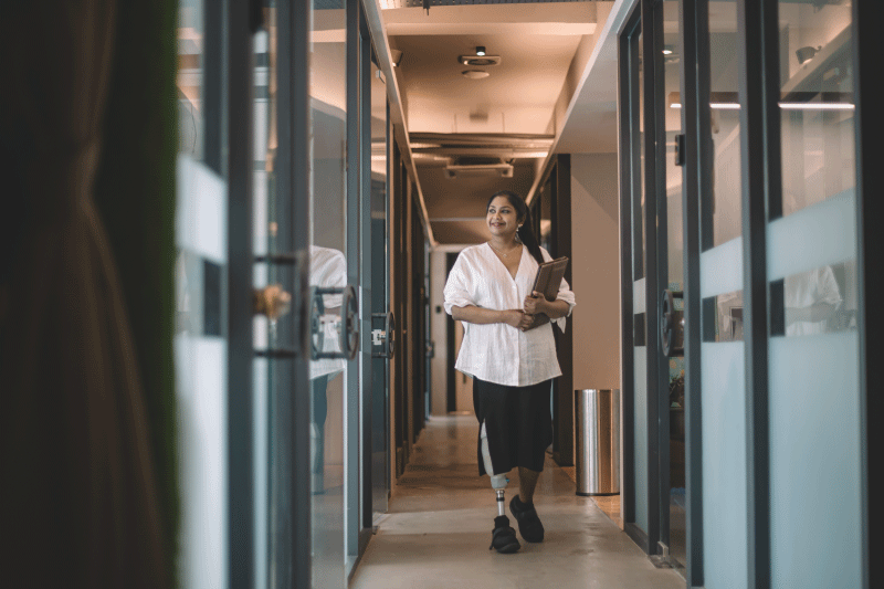 Photo of Microsoft employee walking with artificial let