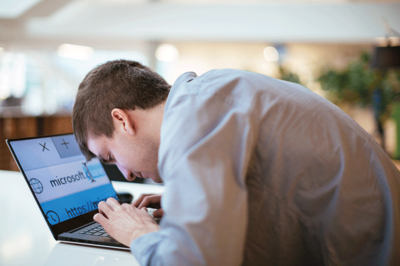 Microsoft employee working on laptop