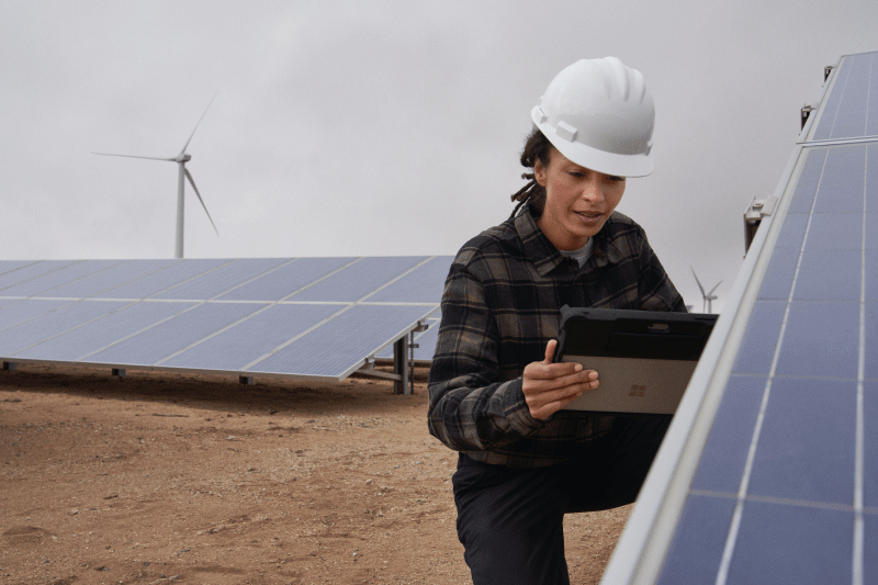 Photo of employee with solar panel array