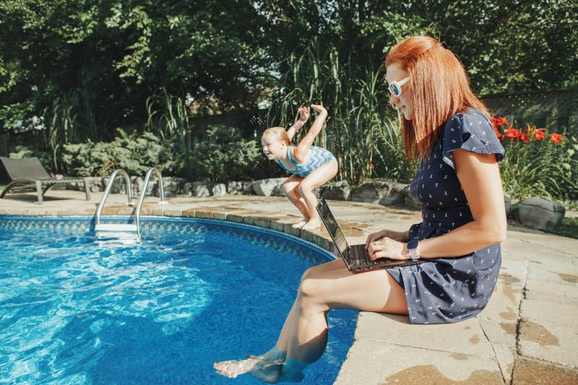 Photo of employee working by home pool